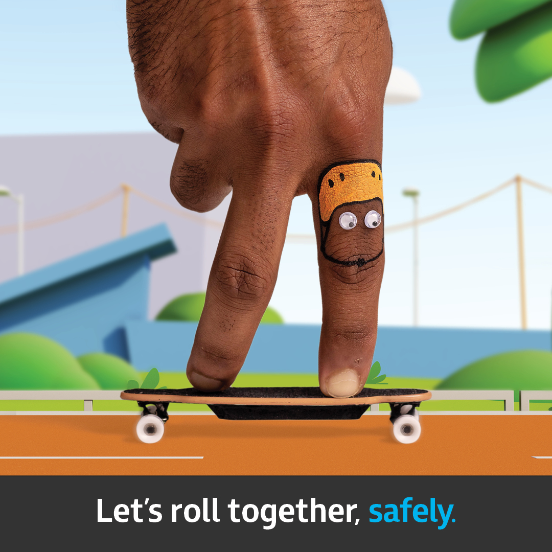 A finger pretending to ride a skateboard down a stylised street