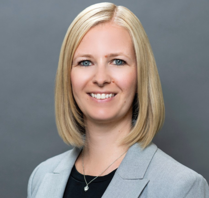 A portrait of Debbie Silvester with a grey background