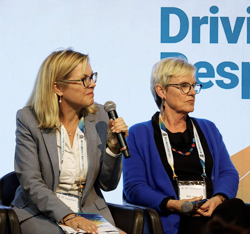 Two women front a panel discussion