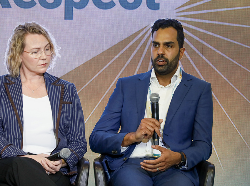 A woman and a man front a panel discussion