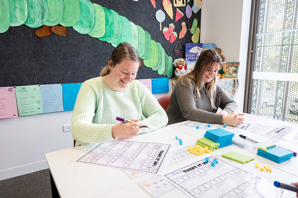 Two TAFE students, preparing classroom activities.