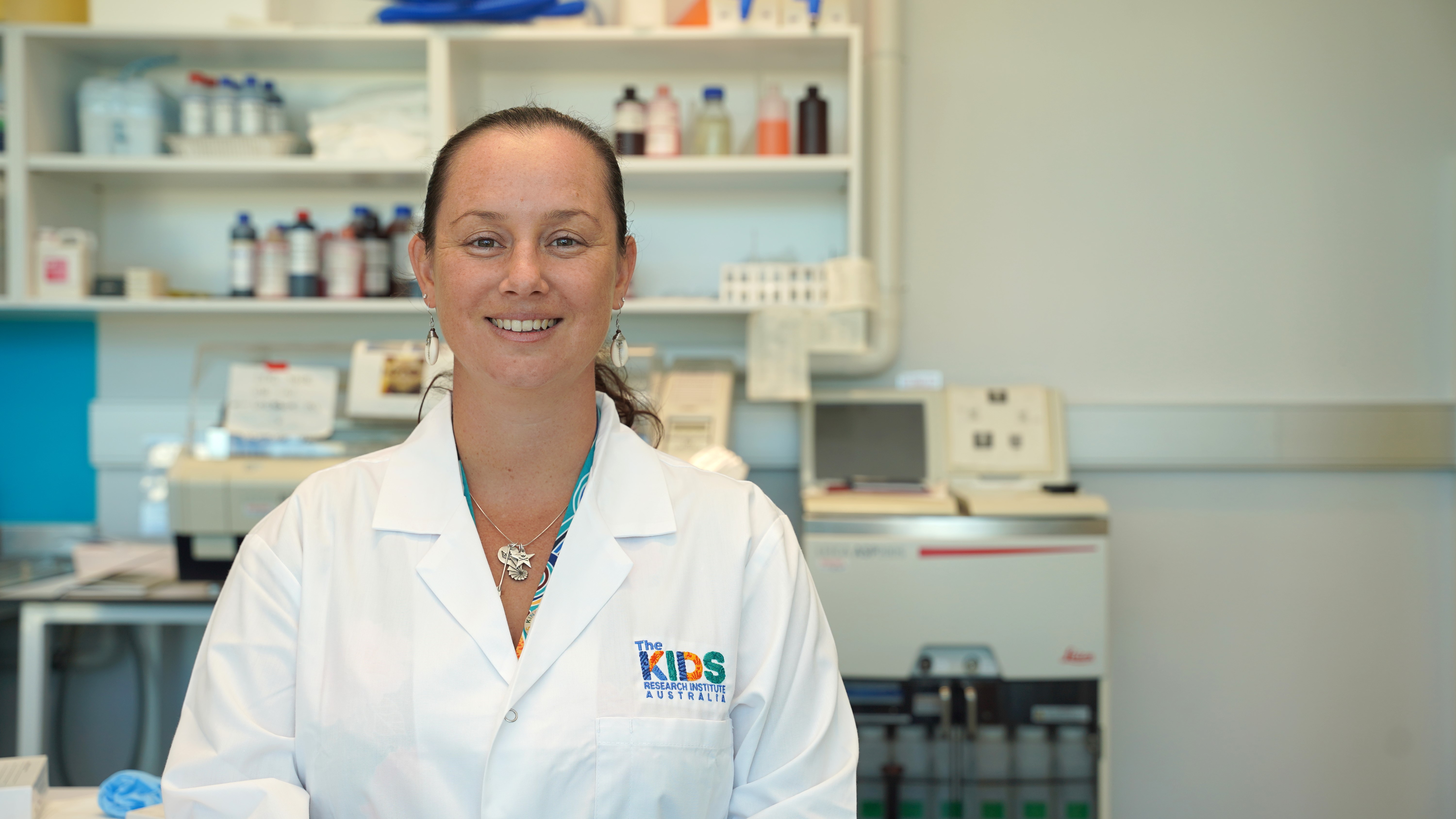psa finalist jessica buck in her lab wearing The Kids Reserrach Institute labcoat 