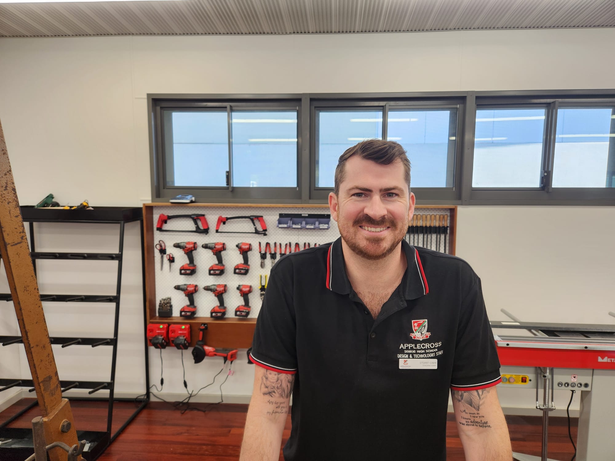 psa finalist stuart carr standing in class with a board of carpentry tools behind him