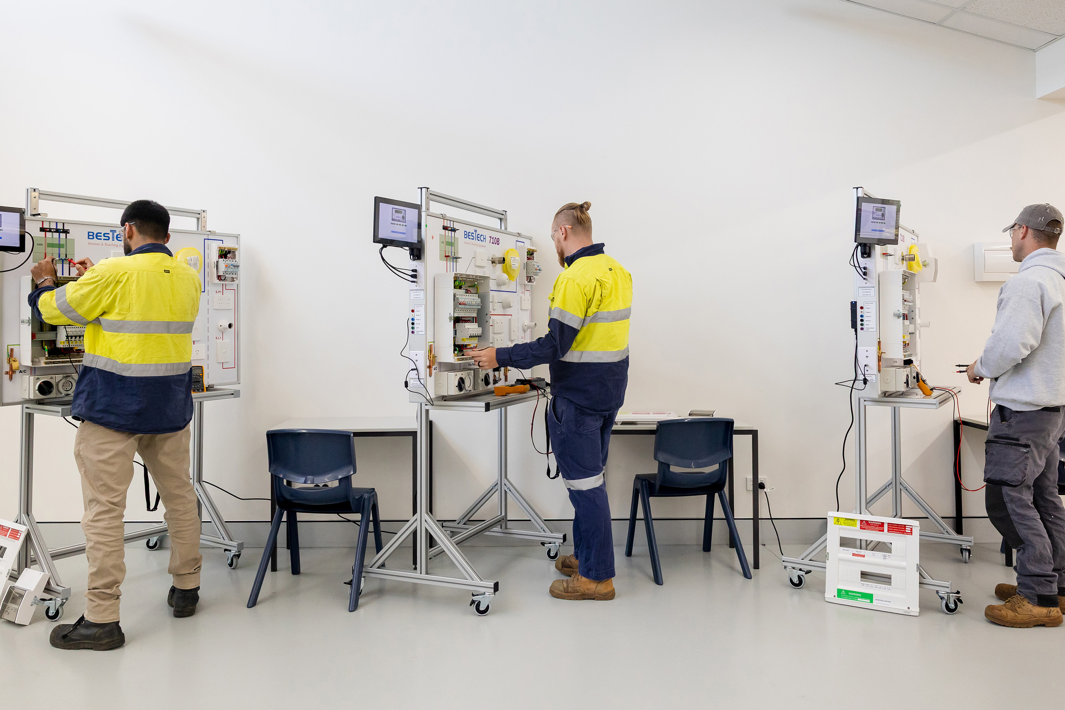 three electricians completing assessment