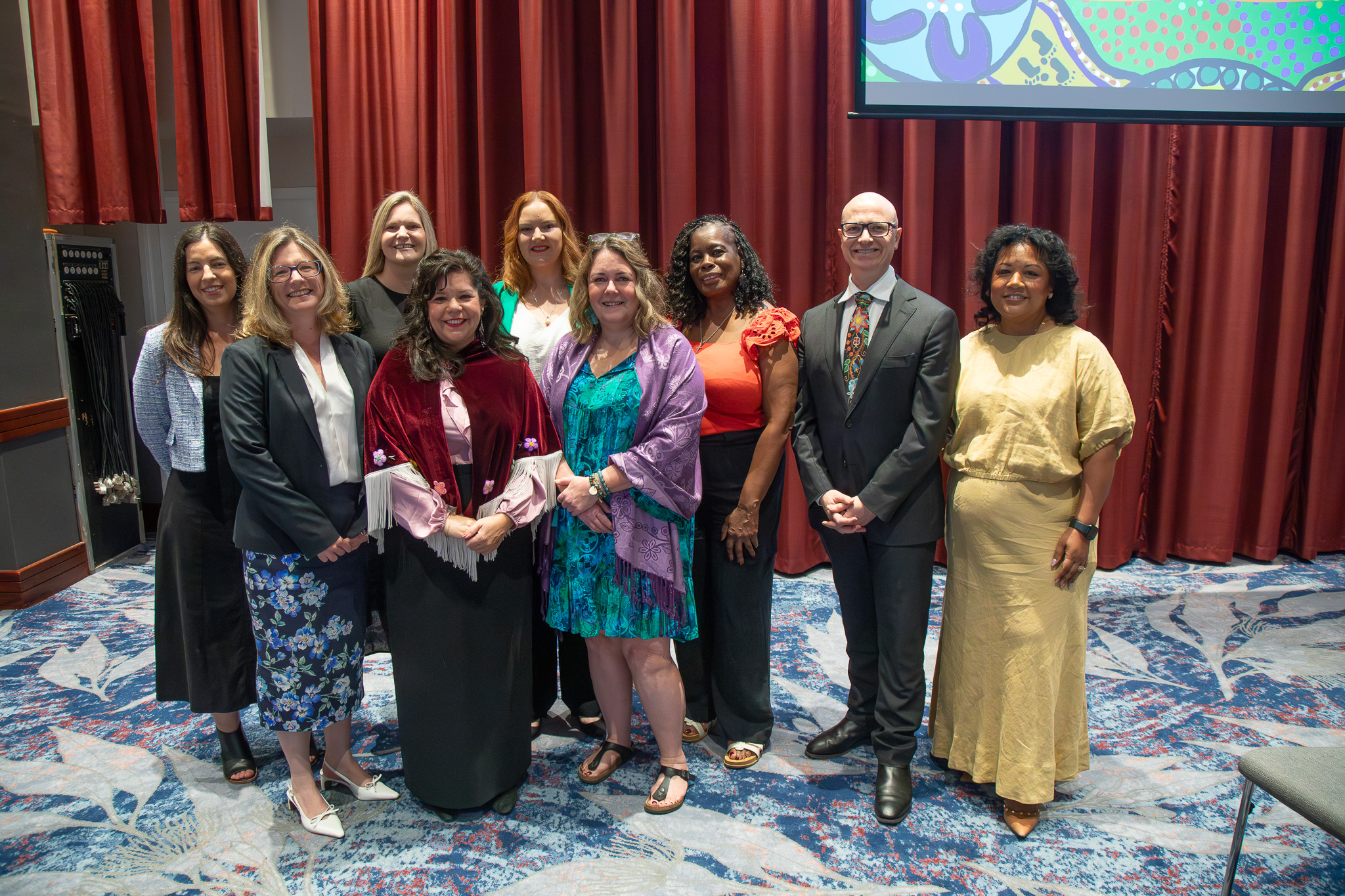 a group of representatives on stage together during the Signs of Safety Gathering