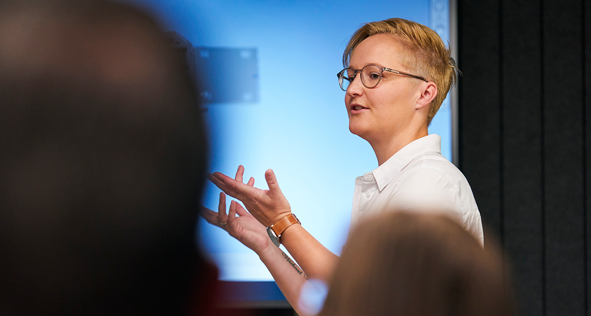 Person presenting to an audience during a workshop or presentation.