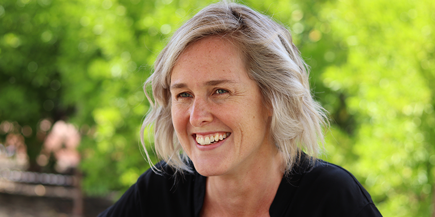 a women sits smiling 