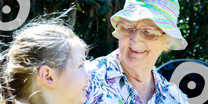 Grandmother and young girl, smiling.