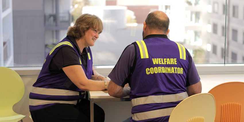 Two State Welfare Emergency Committee members in a meeting.