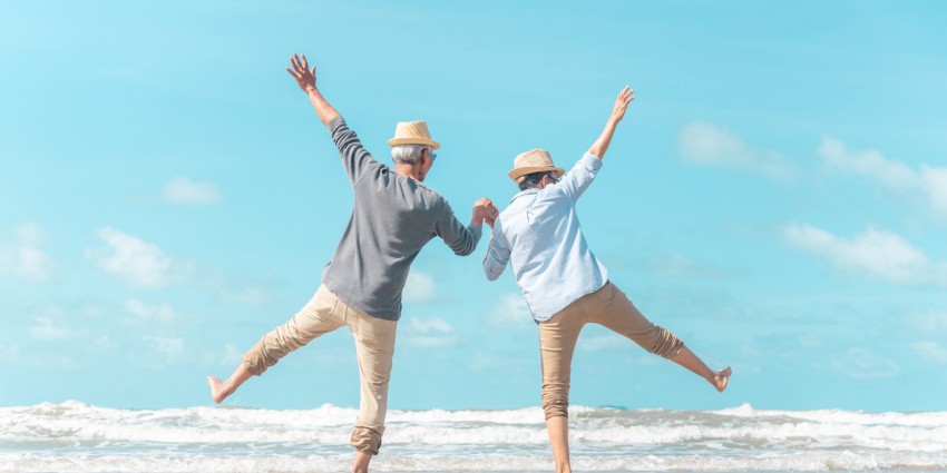 Two older people having fun on the beach.