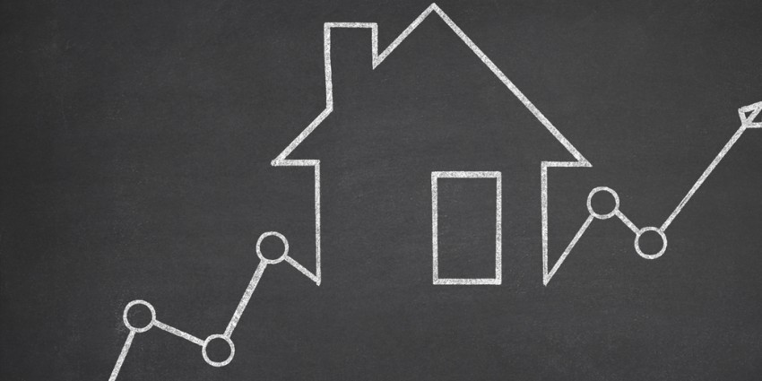 image of a house being drawn on a black board