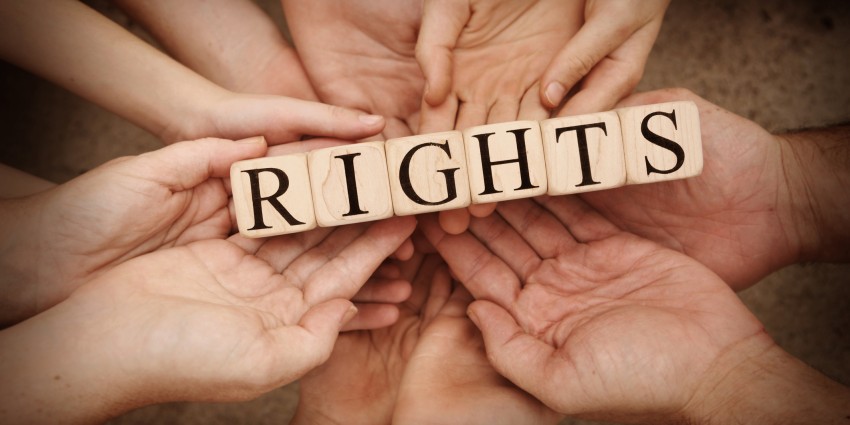 Hands holding the word rights.