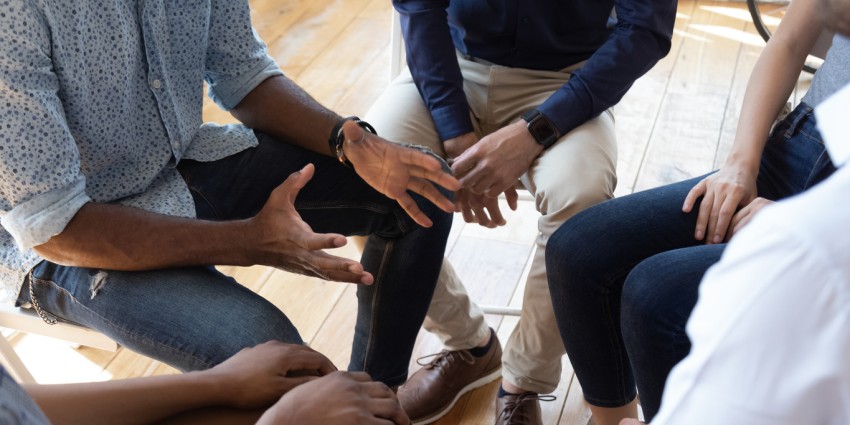People seated in a circle sharing conversations