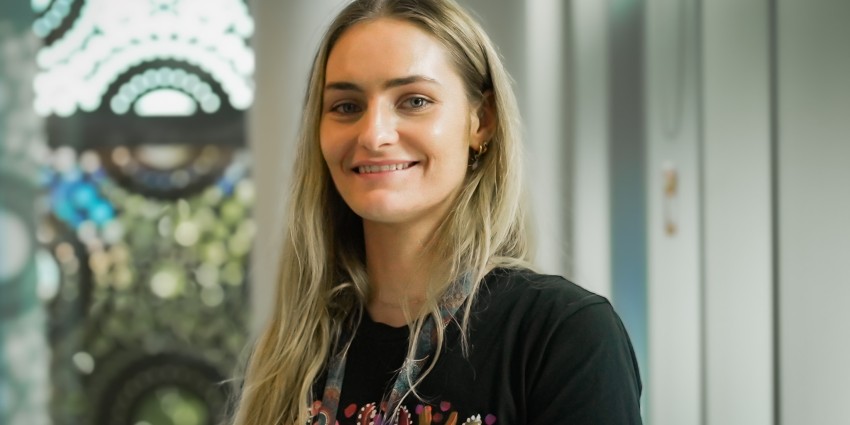photo of a young woman with long brown hair in an office environment