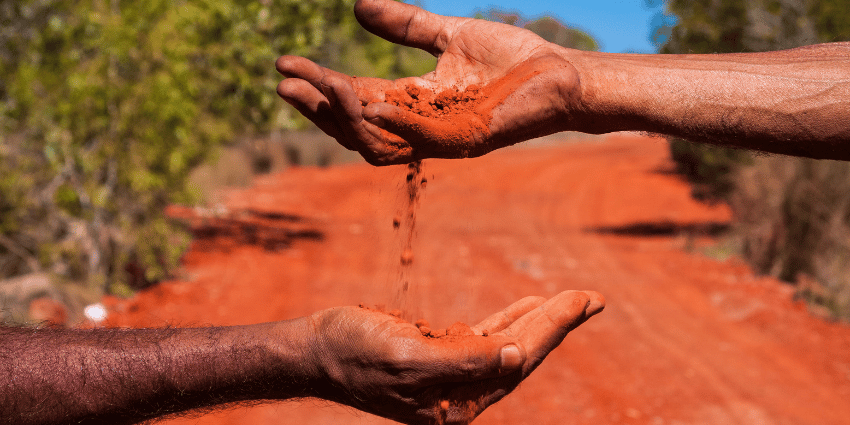 passing red dirt from one hand to another