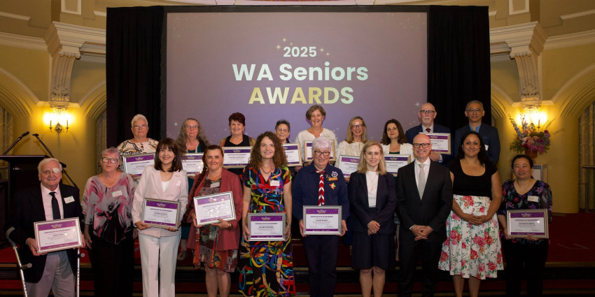 19 people on stage, 17 of which are award winners and finalists at the WA Seniors Awards 2025 ceremony. Also in the photo is the minister and Communities director general