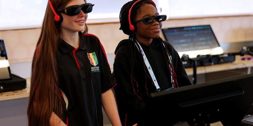 Two kids wearing special glasses engage with the WA Road Safety Commission's interactive platform