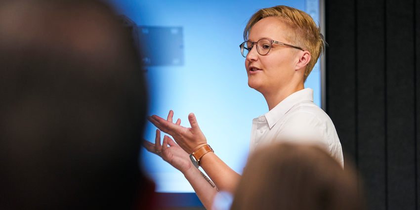 Person presenting to an audience during a workshop or presentation.