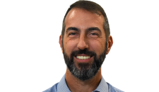Head and shoulders photo of a smartly dressed man with short hair and a beard