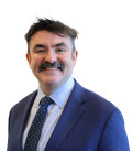 DPC Director General Michael Carey looking at the camera and smiling
